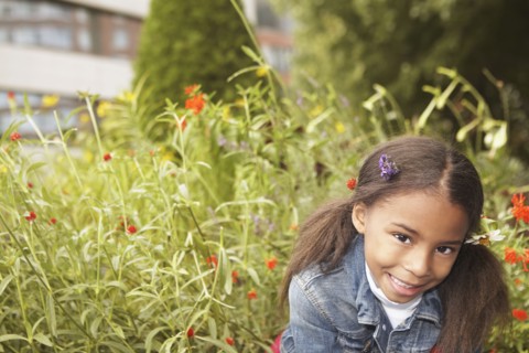 Mixed race girl wearing flowers in her hair