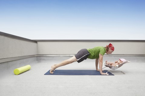 Father practicing yoga and talking to baby
