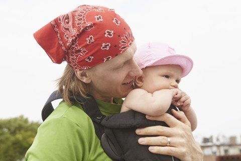 Father carrying baby outdoors