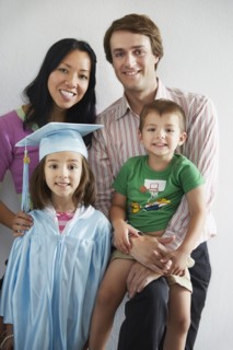 Family with graduating daughter smiling together