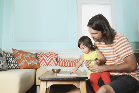 Father and daughter playing in living room