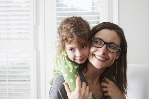 Caucasian mother carrying daughter piggyback