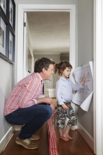 Caucasian father and daughter talking in hallway