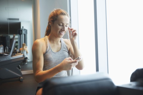 Woman listening to mp3 player in gym