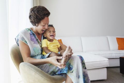 Black mother and son sitting in living room
