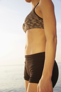 Close up of midsection of woman on beach