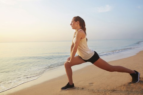 Athlete stretching on beach