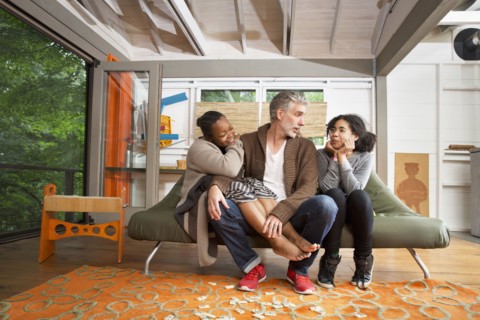 Family hugging in living room