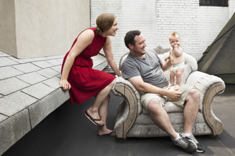 Caucasian family sitting in armchair outdoors