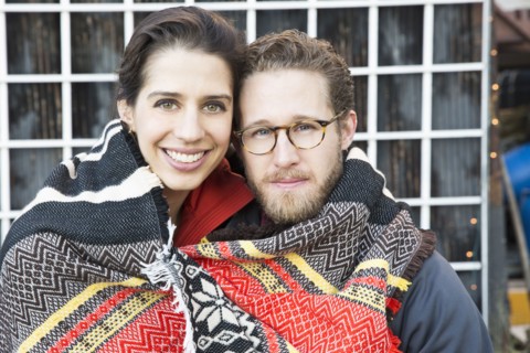 Couple wrapped in blanket outdoors