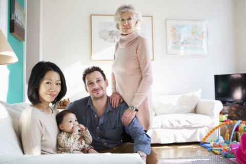 Family and grandmother smiling in living room