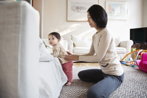 Mother and daughter playing in living room