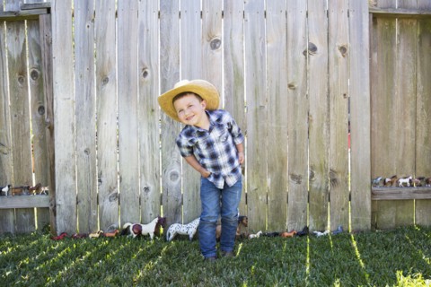 Caucasian boy wearing cowboy hat smiling