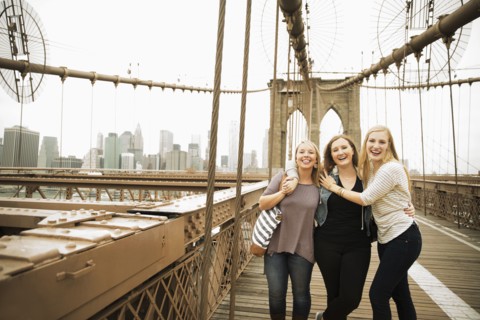 Portrait of smiling Caucasian women posing on bridge