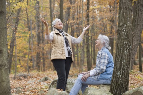 Caucasian women smiling outdoors in autumn