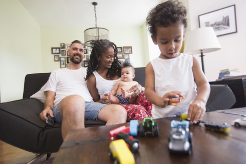 Family relaxing and playing in livingroom