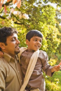 Indian father holding son