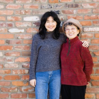 Asian mother and adult daughter hugging