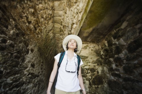Asian woman walking in tunnel