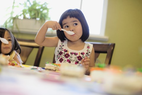 Asian girls eating cake