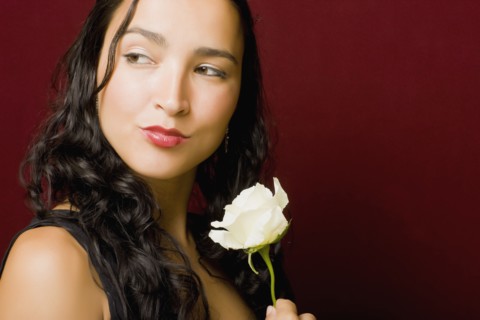 Hispanic woman posing with white rose