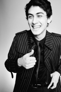 Laughing mixed race man in fashionable coat
