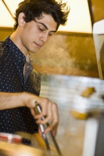 Mixed race man preparing food in kitchen