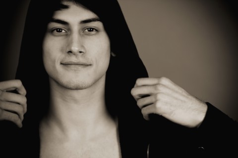 Smiling mixed race man in hooded jacket