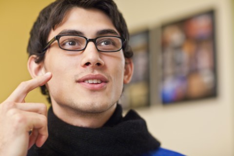 Mixed race man in eyeglasses talking