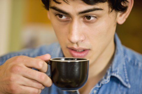 Mixed race man drinking coffee
