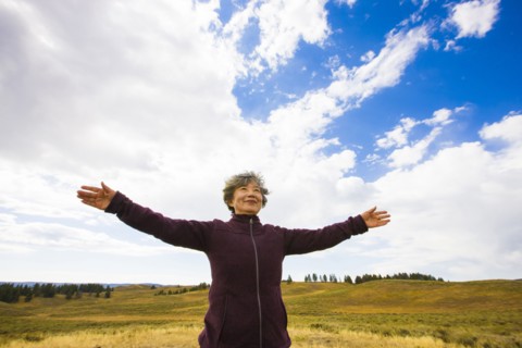 Japanese woman standing in rural landscape