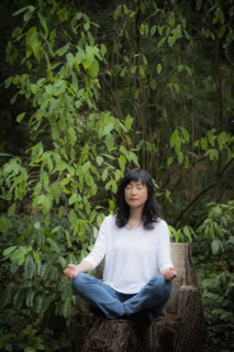 Japanese woman meditating in garden