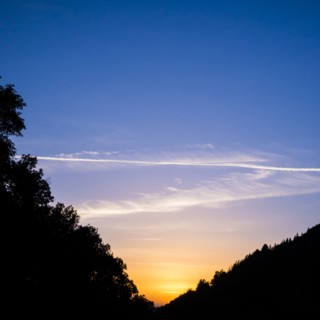 Silhouette of hills under sunrise sky