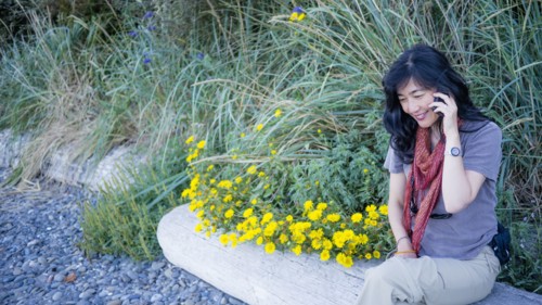 Japanese woman talking on cell phone outdoors