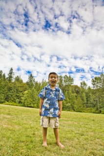 Mixed race boy standing in rural field