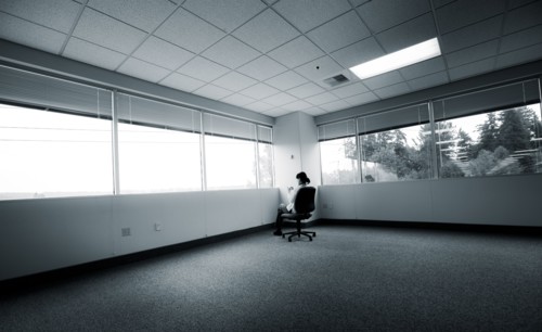 Japanese businesswoman sitting in corner of empty office