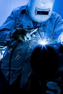 Caucasian welder working in factory