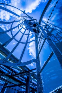 Caucasian man climbing ladder on storage tank