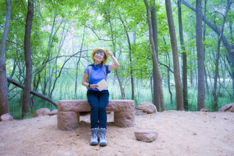 Japanese woman sitting on bench at park