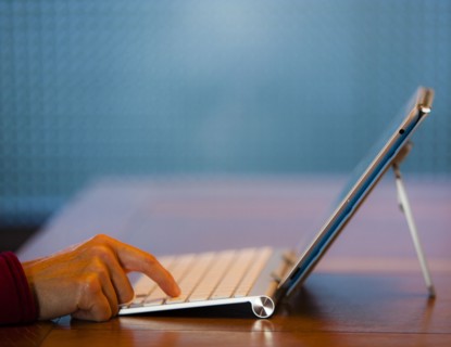 Finger of Japanese woman pressing keyboard for digital tablet