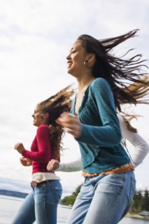 Smiling girls running on beach
