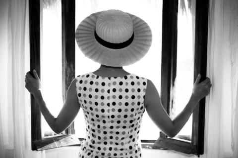 Glamorous woman opening windows