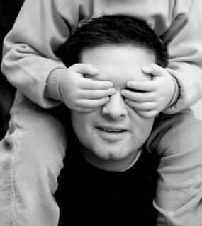 Son covering eyes of father