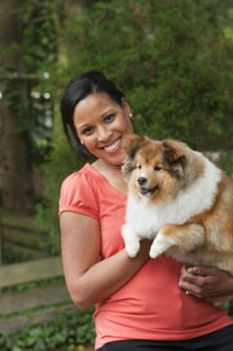 African American woman holding dog