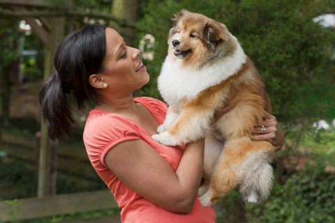 African American woman holding dog