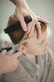 Caucasian mother giving son haircut