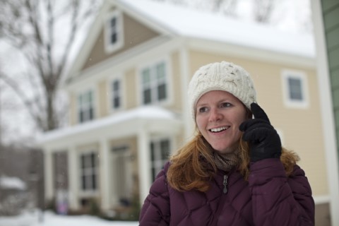 Caucasian woman using cell phone in snow