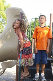 Mixed race children playing on playground