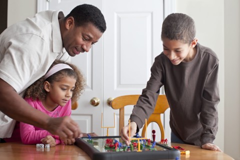 Family playing board game together