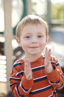 Caucasian boy clapping his hands